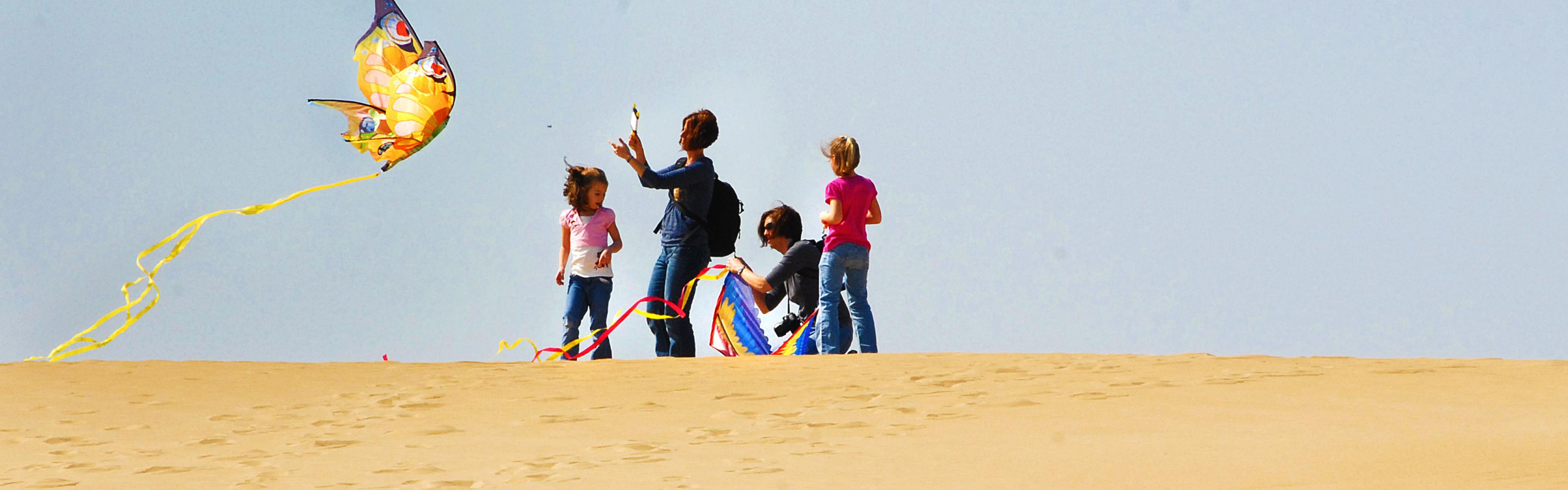 Visitors flying kites above the sand dunes at Jockey’s Ridge State Park